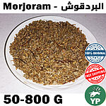 Dried marjoram leaves and stems displayed in a wooden bowl on a rustic surface with scattered whole herb sprigs