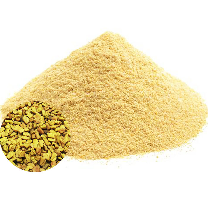 A large mound of golden-yellow fenugreek powder with a circular inset showing whole fenugreek seeds on a white background - Variation