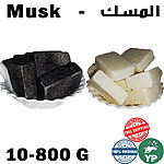 Black musk stone pieces and white musk stone pieces displayed in two separate white ceramic bowls on a white background