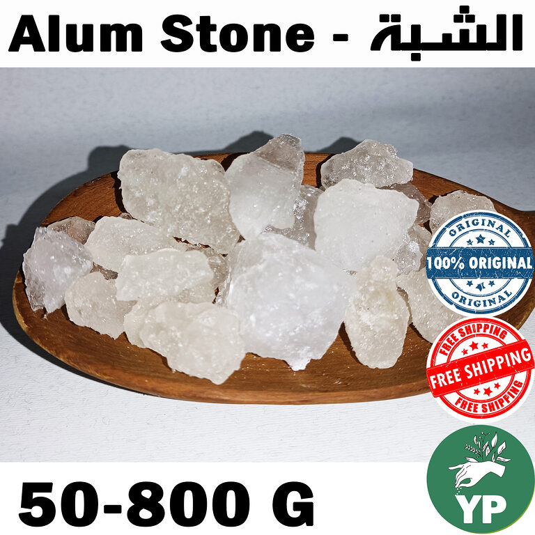 Raw white translucent alum stone crystals piled on a round wooden plate against a light grey background