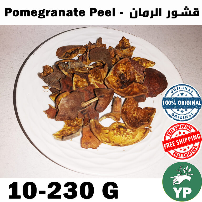 Dried dark brown pomegranate peel pieces arranged on a white ceramic plate, showing natural texture and color variation from deep brown to golden yellow