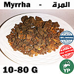 Whole dark amber-brown myrrh resin pieces (Commiphora myrrha) displayed on a white ceramic plate, showing natural texture and color variation