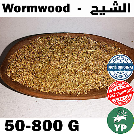 Dried wormwood herb (Artemisia Absinthium) piled on a rustic wooden spoon against a white background, showing golden-green crushed leaves and stems