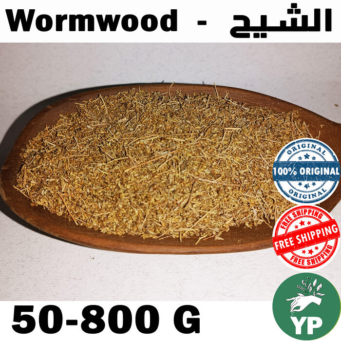 Dried wormwood herb (Artemisia Absinthium) piled on a rustic wooden spoon against a white background, showing golden-green crushed leaves and stems