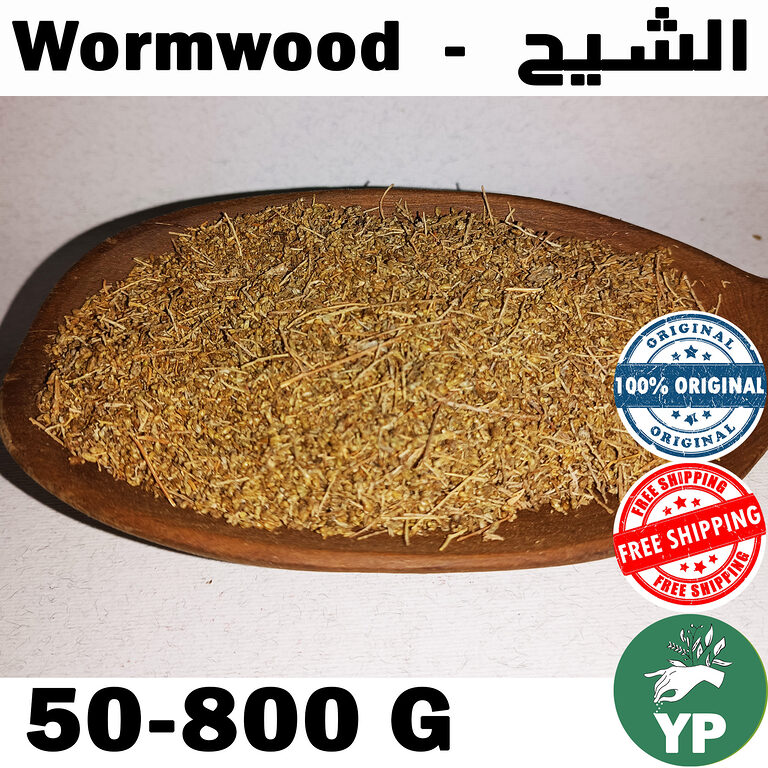 Dried wormwood herb (Artemisia Absinthium) piled on a rustic wooden spoon against a white background, showing golden-green crushed leaves and stems