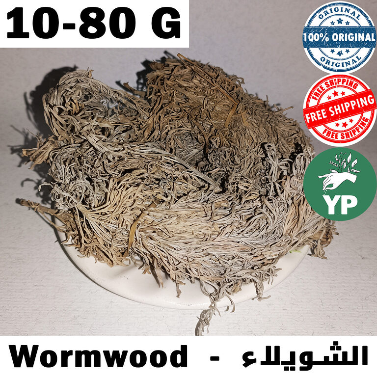 Dried Moroccan wormwood herb (Artemisia absinthium) with silvery-green leaves piled in a white ceramic plate on a light background