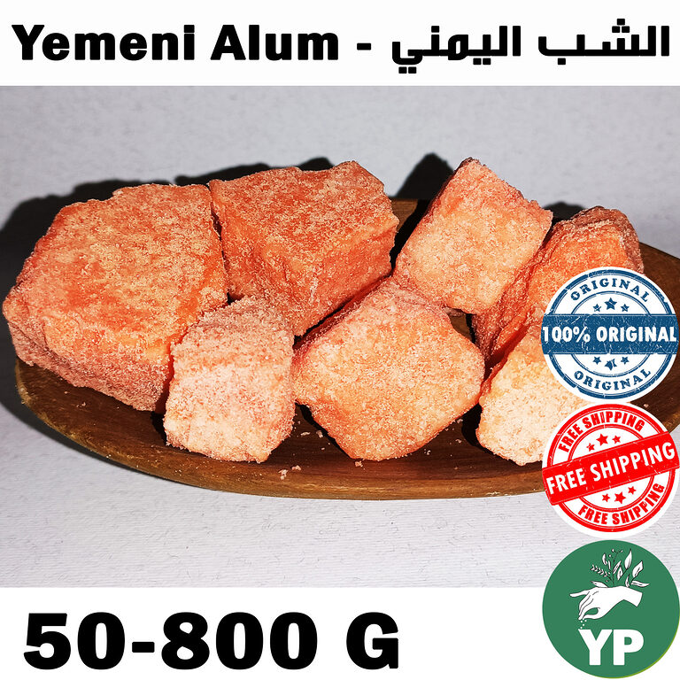Several chunks of reddish-orange Yemeni alum stone arranged on a wooden board, showing their raw crystalline texture and natural terracotta color