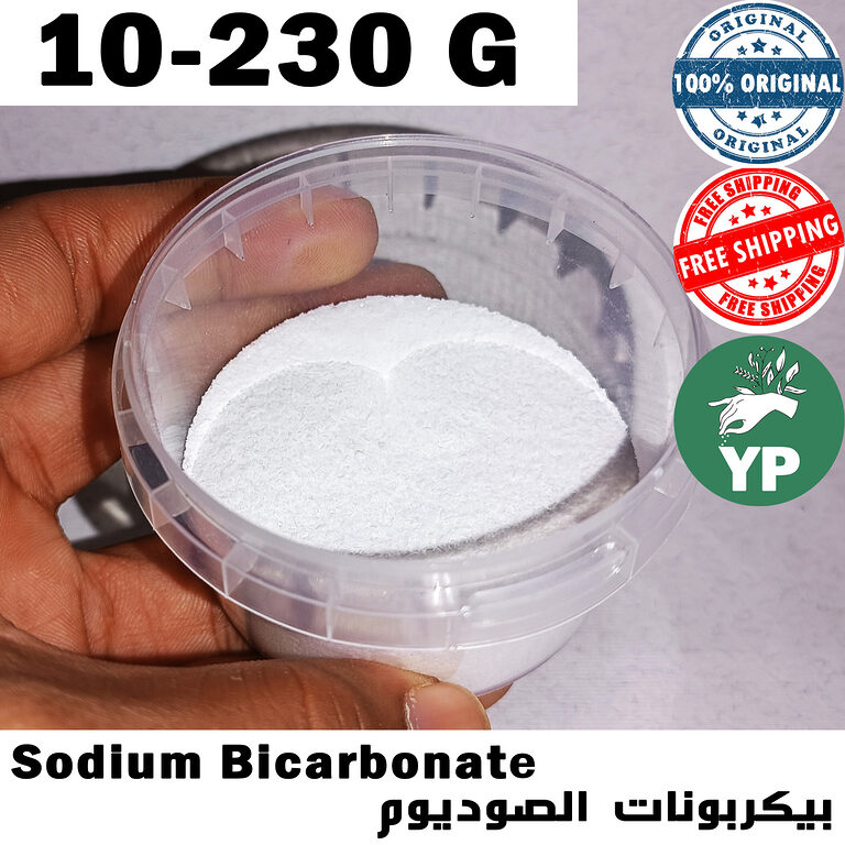 Hand holding a clear plastic container filled with fine white sodium bicarbonate powder, labeled Sodium Bicarbonate in English and Arabic